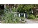 Exterior shot of a single story home with mature trees and a long driveway at 4013 W North B St, Tampa, FL 33609