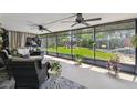 Spacious screened patio with multiple ceiling fans and views of the green backyard at 4240 Woodsville Dr, New Port Richey, FL 34652