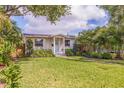 Beautifully landscaped front yard with lush lawn and a charming walkway to the front door at 477 44Th N Ave, St Petersburg, FL 33703