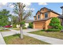 Attractive two-story house with a driveway and an attached two-car garage, set in a well-maintained yard at 5147 Brickwood Rise Dr, Wimauma, FL 33598