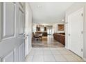Inviting foyer with tile flooring leading to an open-concept living area with wood-look flooring at 5147 Brickwood Rise Dr, Wimauma, FL 33598