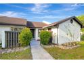 Cozy villa featuring a well-manicured front yard and an inviting entryway at 5310 Bellefield Dr, Tampa, FL 33624