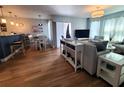 Open-concept living room featuring hardwood floors, modern decor, and plenty of natural light at 5712 Biscayne Ct # 203, New Port Richey, FL 34652