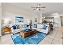 Cozy living room showcasing comfortable seating, a rustic coffee table, and an open layout connecting to the dining area at 600 Bayway Blvd # 504, Clearwater Beach, FL 33767