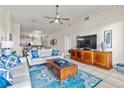 Inviting living room featuring neutral walls, a ceiling fan, and stylish decor that complement the open floor plan at 600 Bayway Blvd # 504, Clearwater Beach, FL 33767