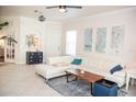 Bright living room with tile floors, white sofa, and natural light at 6931 Surrey Hill Pl, Apollo Beach, FL 33572