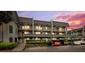 Condominium exterior with assigned covered parking and mature landscaping at 8703 Bardmoor Blvd # 304, Seminole, FL 33777