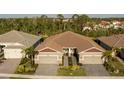 A bird's eye view highlighting this paired villa's layout, landscaping, and surrounding neighborhood at 8732 Rain Song Rd, Sarasota, FL 34238