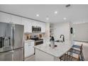 Modern kitchen with white cabinets, stainless steel appliances, and a spacious island with seating at 100 4Th S Ave # 132, St Petersburg, FL 33701