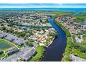 Waterfront homes along winding river, mature trees, with beautiful views of the water, and lush landscaping at 10717 Drummond Rd, Tampa, FL 33615