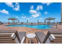Beautiful pool area with lounge chairs and cabanas, offering a relaxing view of the ocean at 11 San Marco St # 407, Clearwater Beach, FL 33767