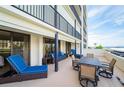 Expansive balcony with comfortable seating, dining set, and sliding glass doors at 1460 Gulf Blvd # 108, Clearwater, FL 33767