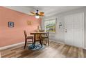 Charming dining area featuring a table with 4 chairs, wood floors and nautical décor at 1701 Pinehurst Rd # 31D, Dunedin, FL 34698