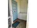 Inviting entryway with a light blue door, brick trim, and a welcome mat at 1903 Canterbury Ln # B2, Sun City Center, FL 33573