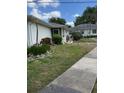 Well-maintained home featuring lush landscaping and a paved walkway at 1903 Canterbury Ln # B2, Sun City Center, FL 33573