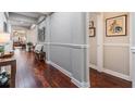 Elegant hallway featuring hardwood floors, neutral walls, and decorative trim at 19529 Lily Pond Ct, Brooksville, FL 34601