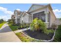 View of the exterior of the home with lush landscaping and a covered porch at 28853 Seedling St, Wesley Chapel, FL 33543