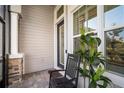 Cozy screened porch with rocking chair, offering a relaxing outdoor space at 28853 Seedling St, Wesley Chapel, FL 33543