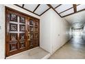 Ornate, solid wood entry door, building hallway, and storage closet at 3021 Countryside Blvd # 45A, Clearwater, FL 33761