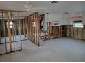 Open living room framed out and ready for renovation with white ceiling fan above at 3919 Harrisburg Ne St, St Petersburg, FL 33703