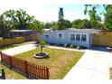 Charming single-story home with a well-manicured front yard, mature trees, and a long driveway at 4106 W Montgomery Ter, Tampa, FL 33616