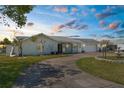 Charming single-story home features a circular driveway, attached garage, and well-manicured lawn at 4210 Headsail Dr, New Port Richey, FL 34652
