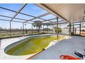 Enclosed pool area showing the in-ground pool requiring maintenance and scenic views at 4210 Headsail Dr, New Port Richey, FL 34652