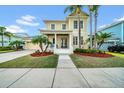 Inviting two-story home with a welcoming front porch, lush landscaping, and a charming facade at 422 Islebay Dr, Apollo Beach, FL 33572