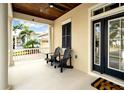 Cozy front porch with seating, offering an inviting outdoor space with view of the neighborhood at 422 Islebay Dr, Apollo Beach, FL 33572