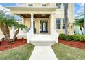 Charming front porch featuring classic columns, wood ceiling, and comfortable seating area at 422 Islebay Dr, Apollo Beach, FL 33572