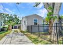 Home featuring updated fence, spacious driveway, and a shed in the backyard at 4516 21St N St, St Petersburg, FL 33714