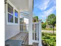 Cozy porch with a wood deck, white railing, and view of the neighborhood at 4516 21St N St, St Petersburg, FL 33714