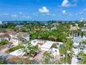 Stunning aerial view showcasing a waterfront property with a private pool, lush greenery, and picturesque ocean views at 5430 Avenida Del Mare, Sarasota, FL 34242