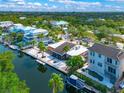 Beautiful aerial view showcasing waterfront homes along a canal with boat docks and lush tropical landscaping at 5430 Avenida Del Mare, Sarasota, FL 34242
