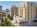 An aerial view captures the building's facade, balconies and rooftop pool with lounge area at 628 Cleveland St # 612, Clearwater, FL 33755