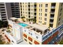 Rooftop pool featuring lounge chairs, pergola, and views at 628 Cleveland St # 612, Clearwater, FL 33755