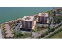 Aerial view of waterfront condos with lush landscaping, offering serene views and convenient parking at 7432 Sunshine Skyway S Ln # 406, St Petersburg, FL 33711