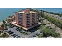 Waterfront condo exterior view with multiple balconies, parking, and well-maintained landscaping at 7432 Sunshine Skyway S Ln # 406, St Petersburg, FL 33711