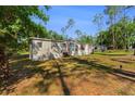 Single story home with metal siding and stairs leading to the front door at 7537 Old Pasco Rd, Wesley Chapel, FL 33544