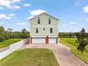 Charming two-story home featuring an attached three-car garage and a brick driveway at 8932 Rocky Creek Dr, Tampa, FL 33615