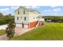 A beautiful two-story home featuring an attached three-car garage at 8932 Rocky Creek Dr, Tampa, FL 33615