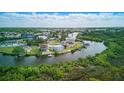 Aerial view of waterway with the two story duplex and surrounding landscape at 8940 Rocky Creek Dr, Tampa, FL 33615