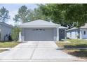 A well-manicured lawn complements this single-story home and two-car garage at 10728 Navigation Dr, Riverview, FL 33579