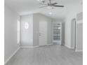 Spacious living room with bright neutral paint and new gray wood-look flooring at 10728 Navigation Dr, Riverview, FL 33579