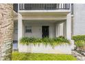 Welcoming entryway with a secure gate, surrounded by vibrant greenery at 122 N Kings Ave # 101, Brandon, FL 33510