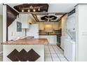 Cozy kitchen with unique ceiling and stylish appliances, including a stacked washer/dryer at 122 N Kings Ave # 101, Brandon, FL 33510