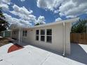 Well-maintained single-story home with a fresh exterior paint job and a spacious driveway at 12801 College Hill Dr, Hudson, FL 34667