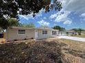 Charming single-story home with manicured lawn and a welcoming front porch at 12801 College Hill Dr, Hudson, FL 34667