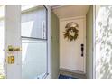 Charming front door with wreath, sidelight, and screen door, offering a warm welcome at 13512 Palmwood Ln # 13512, Tampa, FL 33618