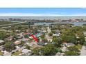 Aerial view of the property, showcasing its location near the water and cityscape with a red arrow pointing to the house at 14199 82Nd Avenue, Seminole, FL 33776